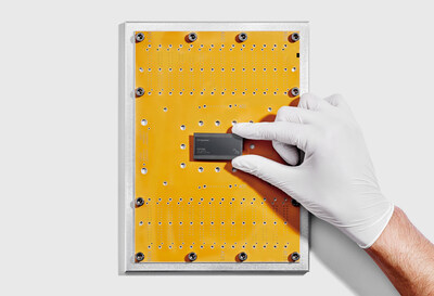 IBM researcher holds IBM Quantum Nighthawk chip (Credit: IBM)